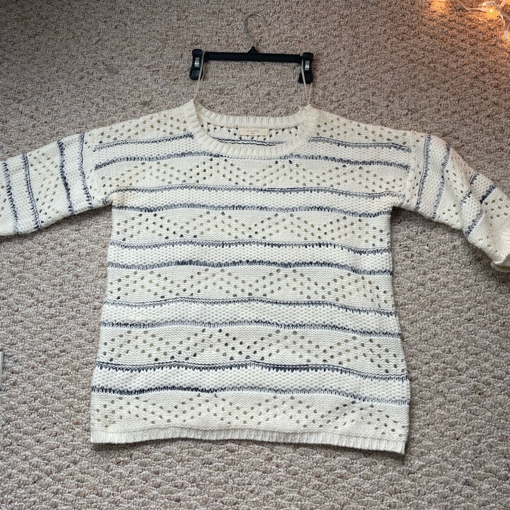Crème sweater with blue lines across.
